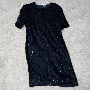 Little black dress. Silk lined, back slit. Pretty beaded and sequined details.